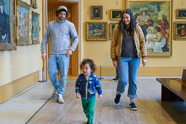 Family of three walking through the Barnes